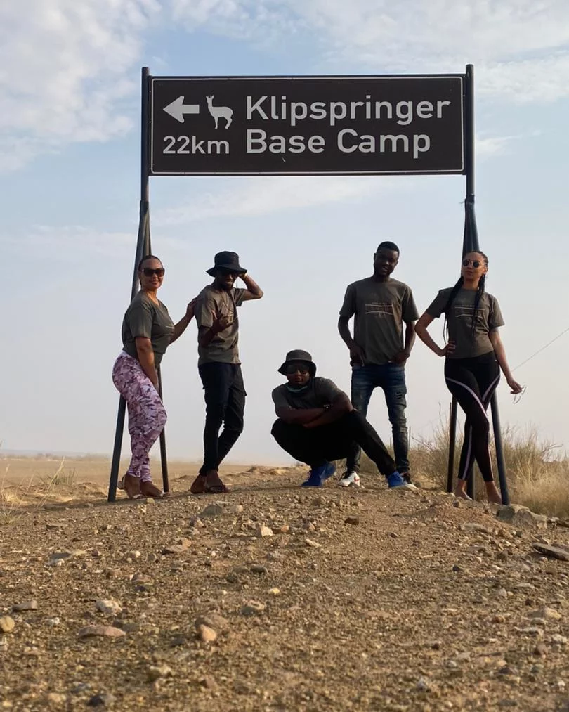 Stephanie and fellow hikers beneath the Klipspringer 22 kilometre Base Camp sign